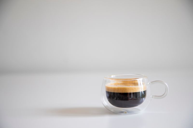 Italian Espresso served in a small cup with biscotti